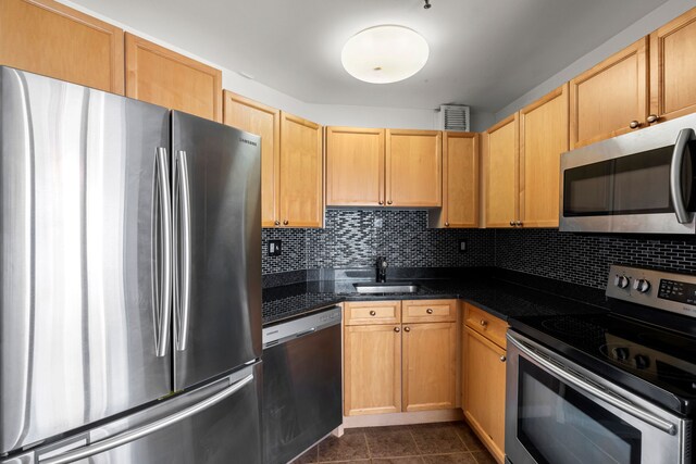 kitchen with tasteful backsplash, stainless steel appliances, sink, and light brown cabinets