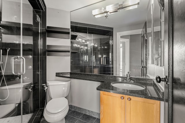 bathroom with vanity, walk in shower, tile patterned floors, and toilet