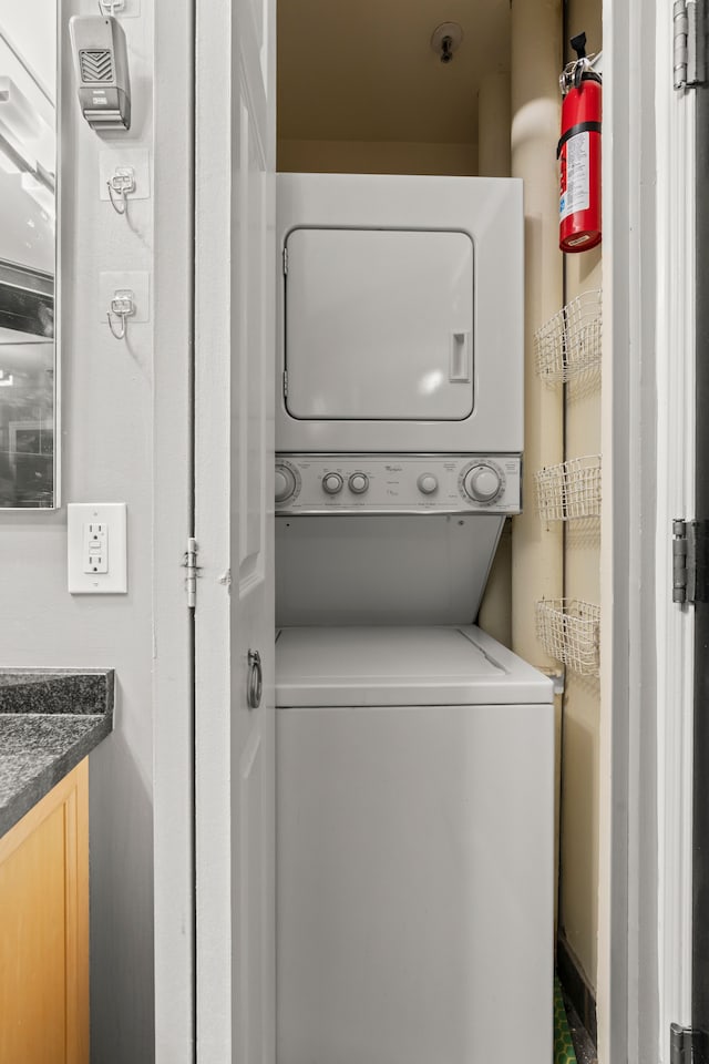 laundry area featuring stacked washer and clothes dryer