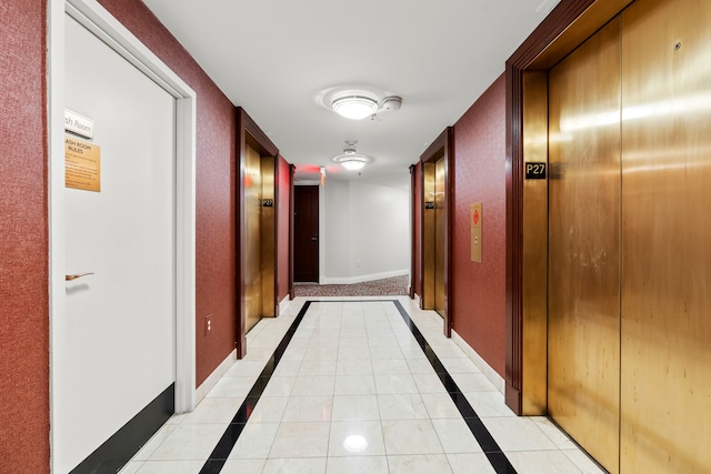 corridor with elevator and light tile patterned flooring