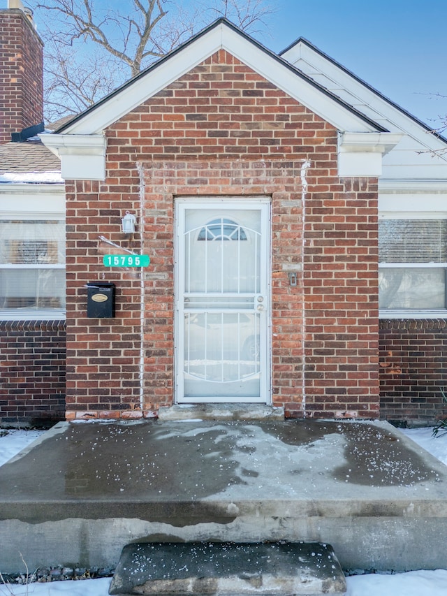 view of snow covered property entrance