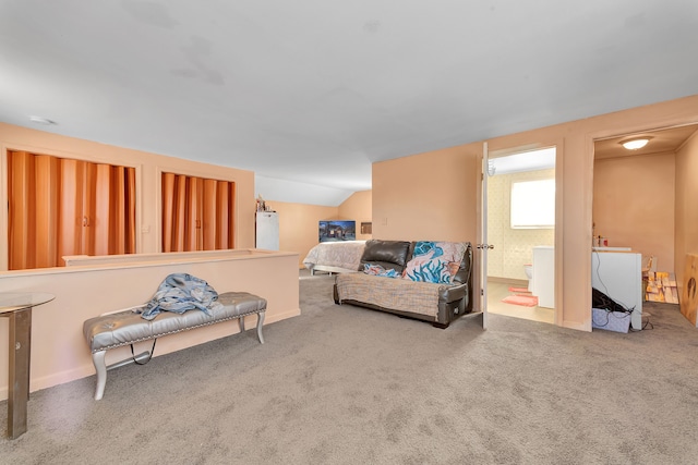 carpeted living room featuring vaulted ceiling