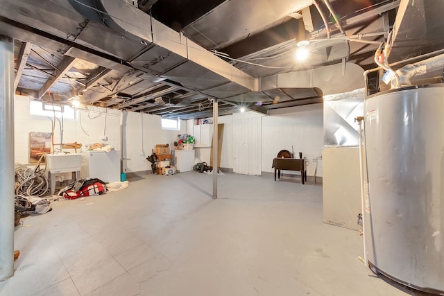 basement with gas water heater, separate washer and dryer, and sink