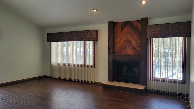 unfurnished living room with recessed lighting, baseboards, a tiled fireplace, and hardwood / wood-style flooring