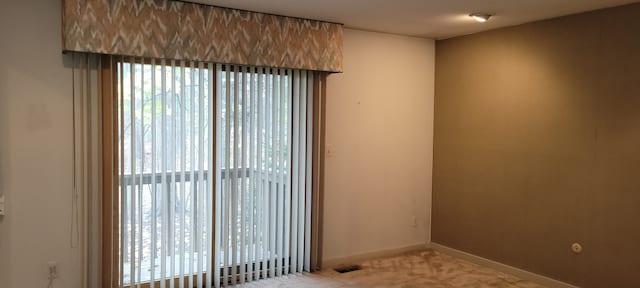 spare room featuring visible vents and baseboards