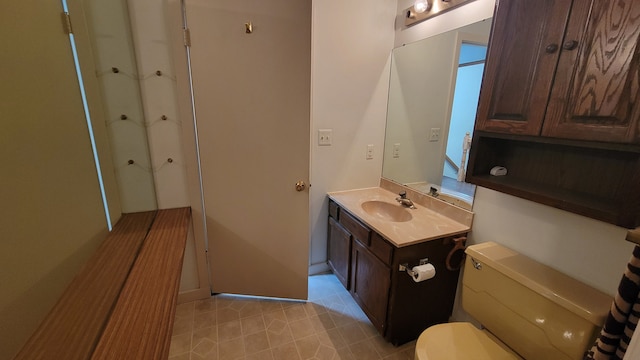 bathroom featuring toilet and vanity