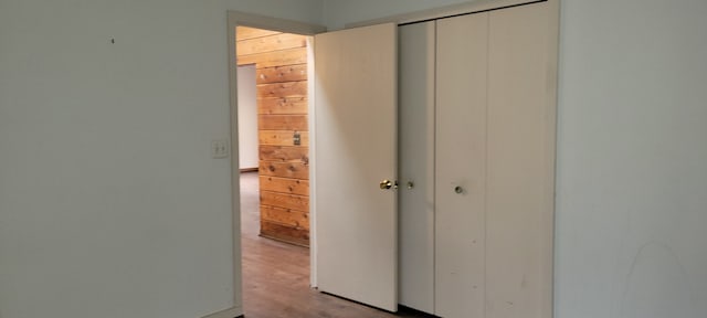 unfurnished bedroom with wood finished floors and a closet