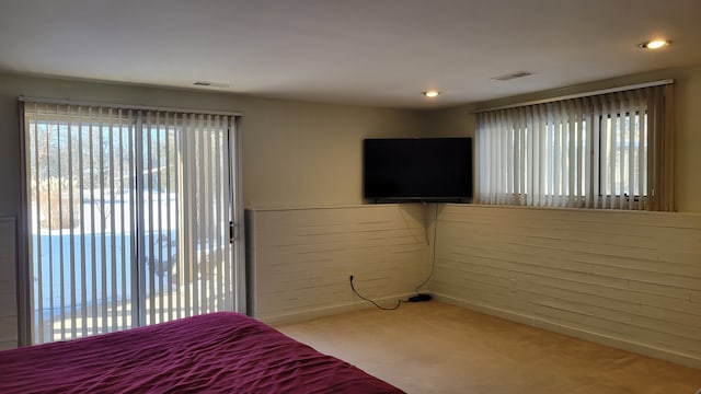 unfurnished bedroom featuring access to outside, carpet flooring, recessed lighting, and visible vents