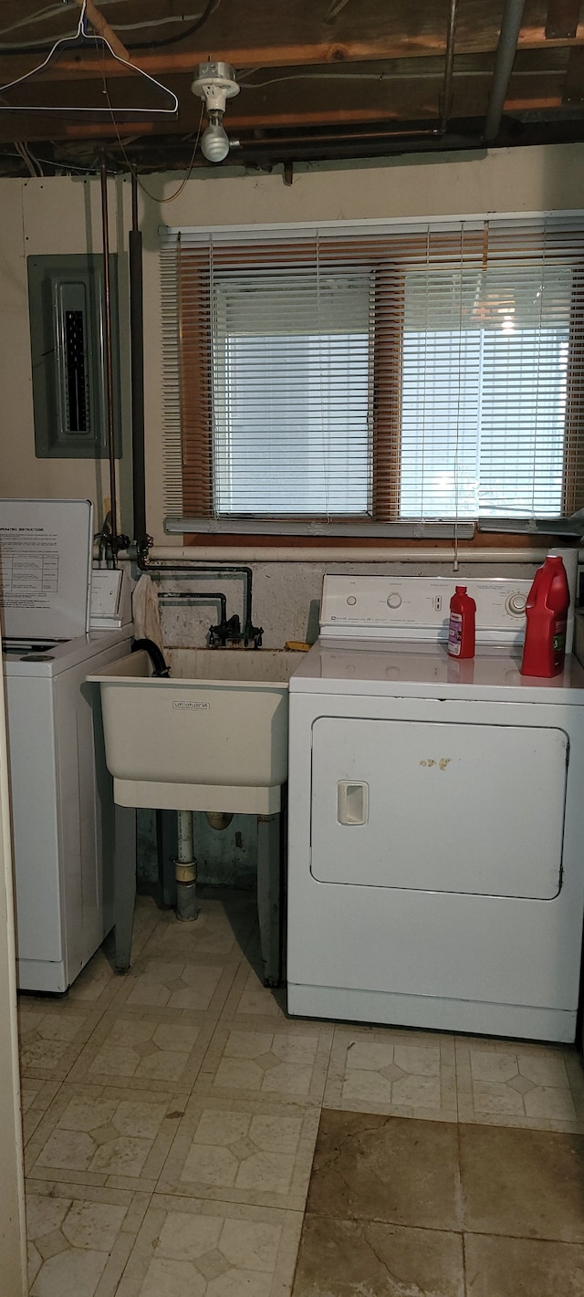 washroom featuring electric panel, laundry area, and washing machine and clothes dryer