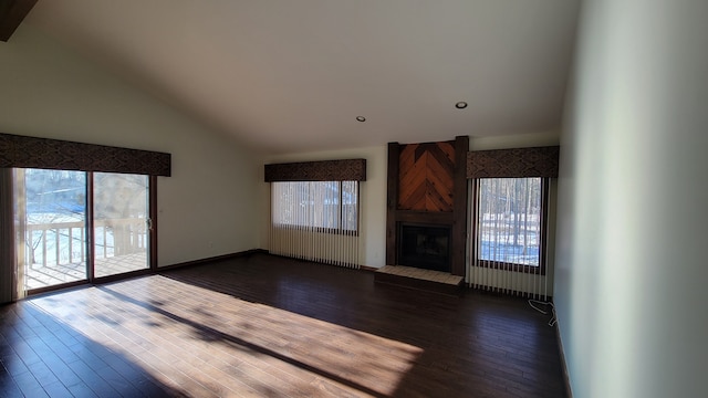 unfurnished living room with dark wood-type flooring, a fireplace, and high vaulted ceiling