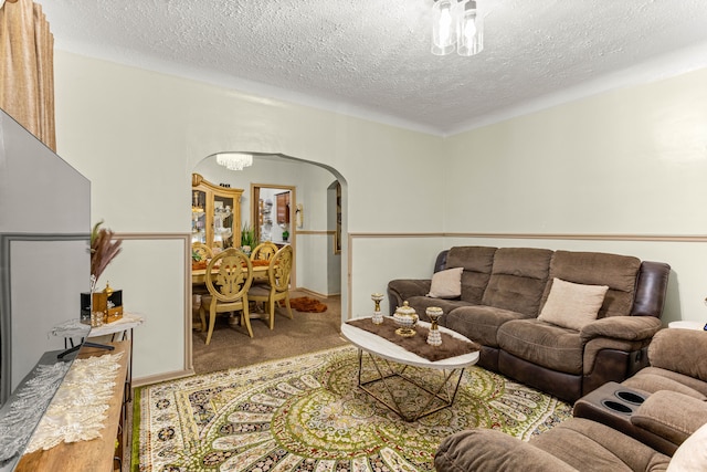 living room featuring a textured ceiling and carpet flooring