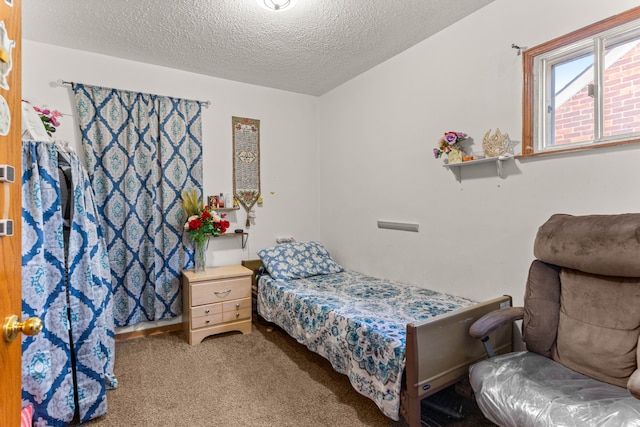 carpeted bedroom featuring a textured ceiling