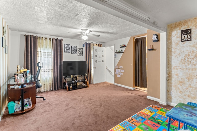 rec room with carpet floors, a textured ceiling, and ceiling fan