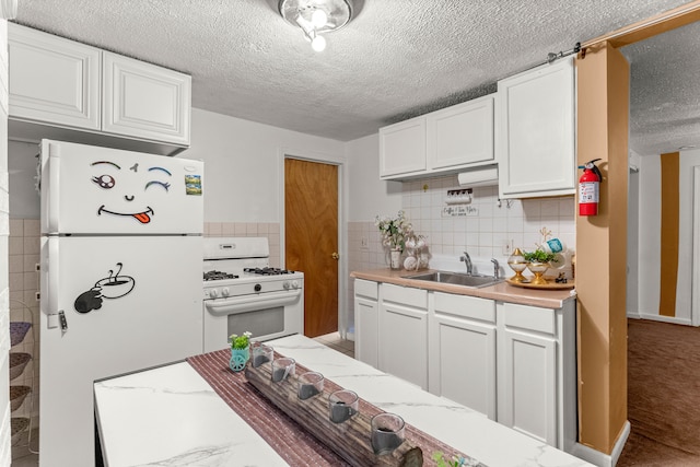 kitchen with white cabinetry, carpet floors, sink, backsplash, and white appliances