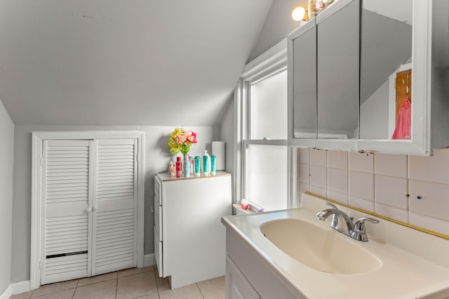 bathroom featuring lofted ceiling, vanity, tasteful backsplash, and tile patterned floors