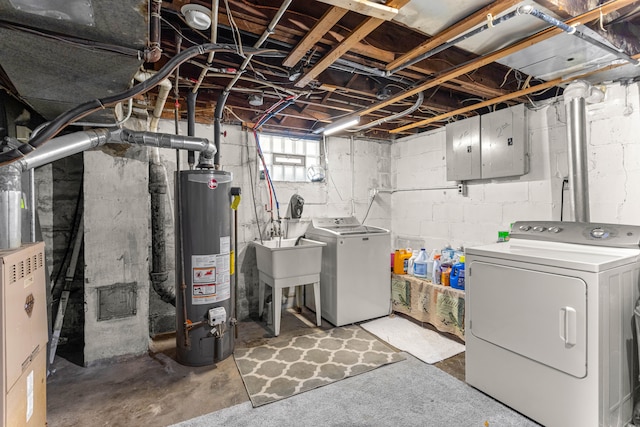 basement with gas water heater, sink, and washing machine and clothes dryer