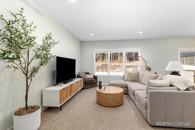 living room featuring recessed lighting, light colored carpet, and visible vents