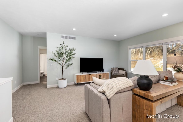 living room with recessed lighting, visible vents, carpet floors, and baseboards