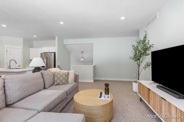 living area featuring light carpet, visible vents, recessed lighting, and baseboards