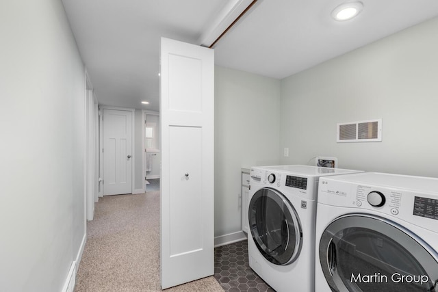 clothes washing area with independent washer and dryer, laundry area, baseboards, and visible vents