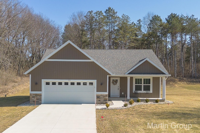 view of front facade with an attached garage, a shingled roof, a front lawn, concrete driveway, and stone siding