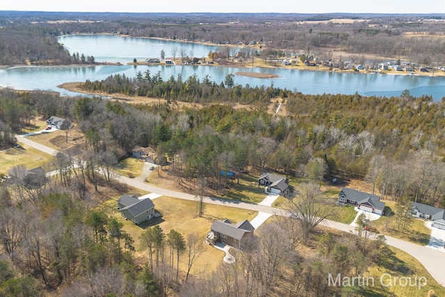 aerial view with a wooded view and a water view