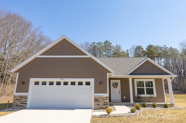 view of front facade with driveway, stone siding, a porch, roof with shingles, and an attached garage