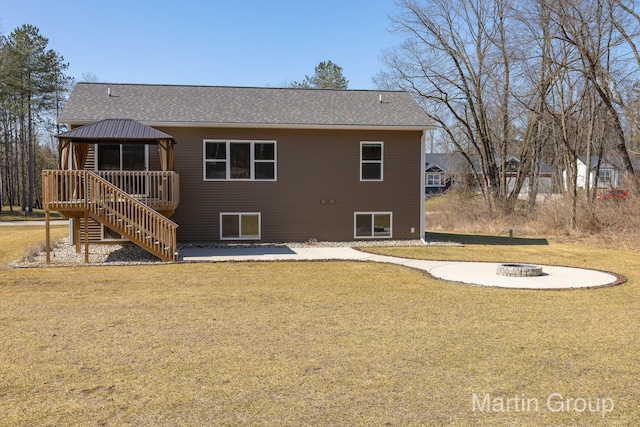 back of property with an outdoor fire pit, a gazebo, stairway, a yard, and a patio area