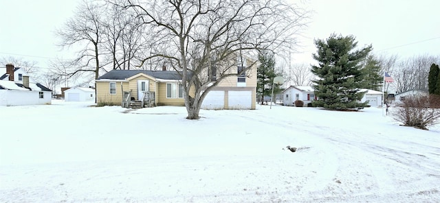 yard covered in snow with a garage