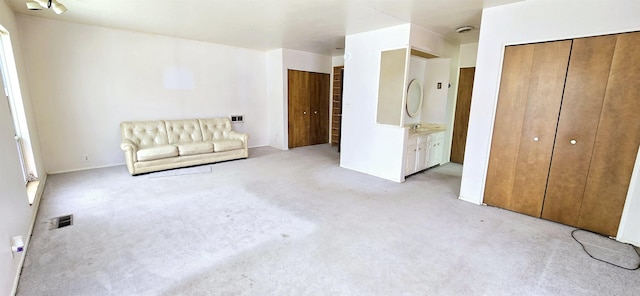 unfurnished room featuring light colored carpet