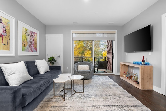 living room with dark hardwood / wood-style flooring