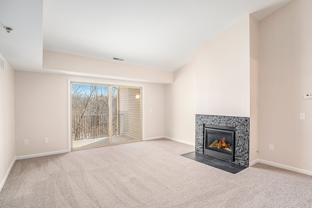 unfurnished living room with a fireplace, vaulted ceiling, and carpet