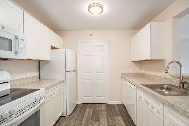 kitchen with white cabinetry, sink, white appliances, and dark hardwood / wood-style floors