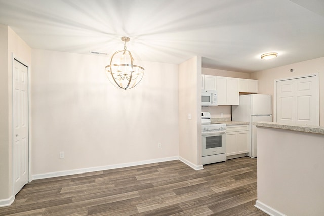 kitchen featuring dark hardwood / wood-style floors, white cabinets, white appliances, and decorative light fixtures