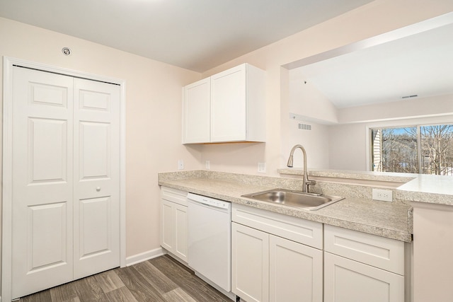 kitchen with dishwasher, sink, white cabinets, dark hardwood / wood-style flooring, and kitchen peninsula