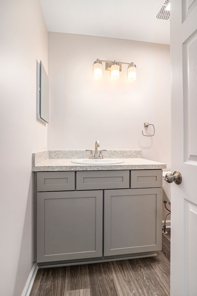 bathroom featuring vanity and hardwood / wood-style flooring