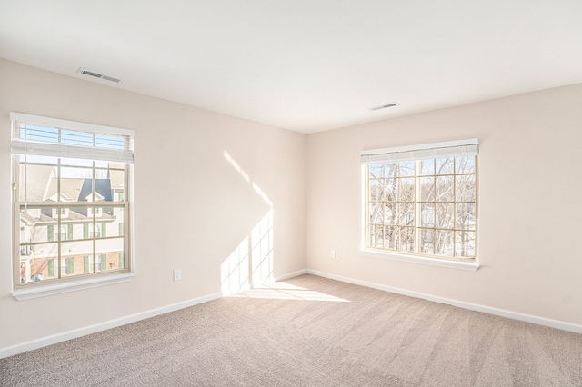 empty room featuring light carpet