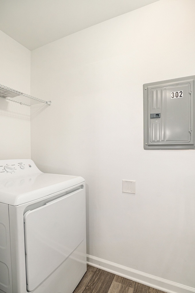 clothes washing area featuring dark hardwood / wood-style floors, washer / clothes dryer, and electric panel