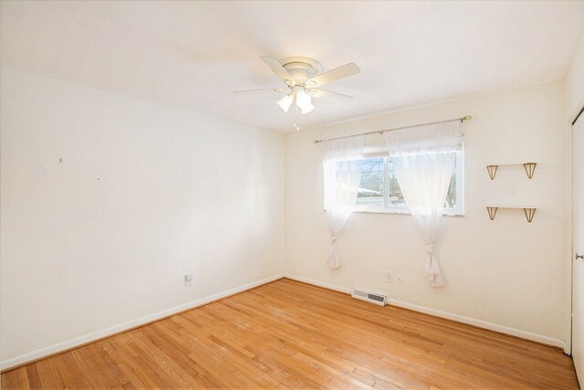 unfurnished room featuring ceiling fan and hardwood / wood-style floors