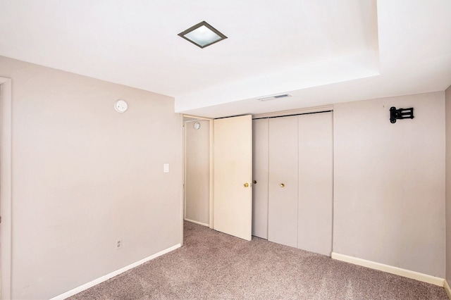 unfurnished bedroom featuring carpet floors and a closet