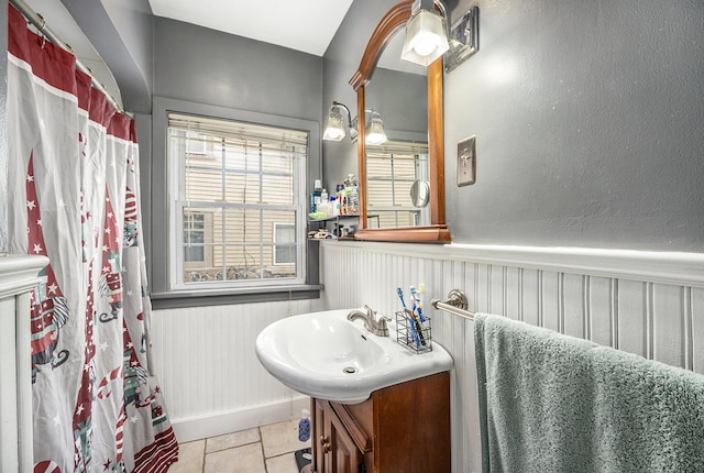 bathroom with sink, curtained shower, and tile patterned floors