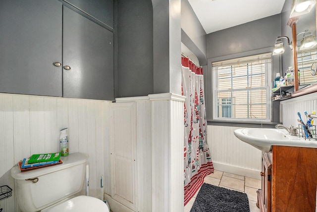 bathroom featuring walk in shower, tile patterned floors, toilet, and sink