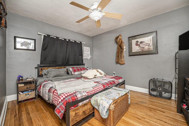 bedroom with wood-type flooring and ceiling fan