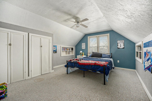 bedroom with ceiling fan, lofted ceiling, carpet floors, and a textured ceiling