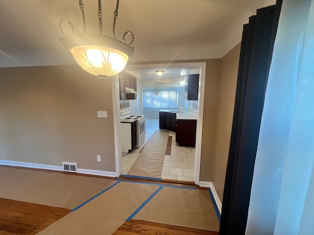 hallway featuring light tile patterned flooring