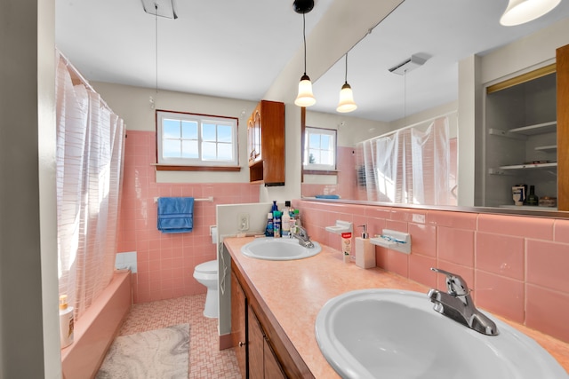 full bathroom with shower / tub combo with curtain, toilet, tile walls, vanity, and tile patterned flooring