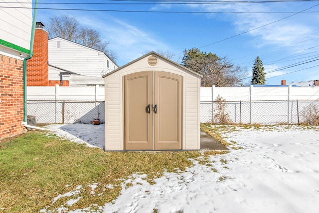 snow covered structure featuring a yard