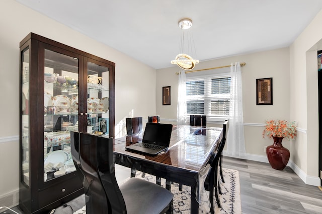 dining area featuring a chandelier and light hardwood / wood-style flooring