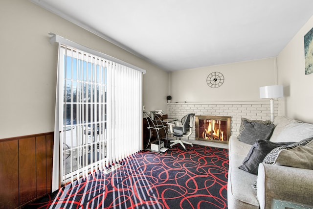 living room with carpet floors and a brick fireplace