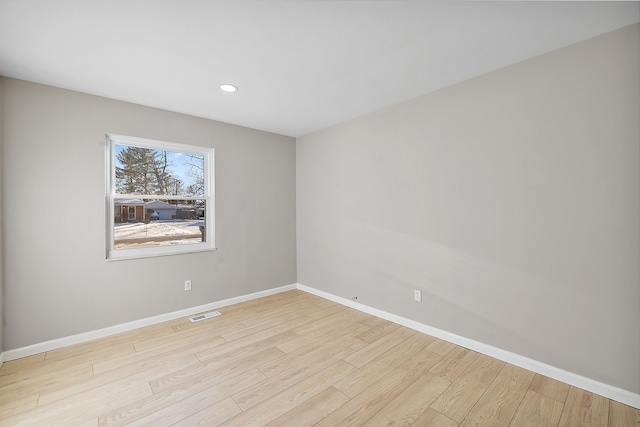 empty room with light hardwood / wood-style flooring